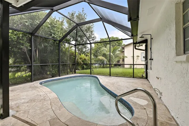 View of pool featuring a patio area and a lanai