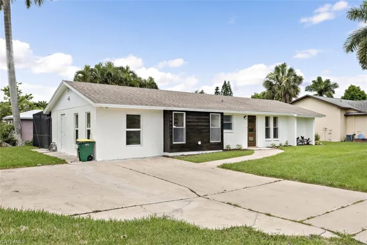 Ranch-style home featuring a front yard