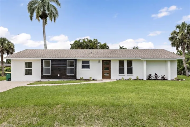Ranch-style house with a front lawn