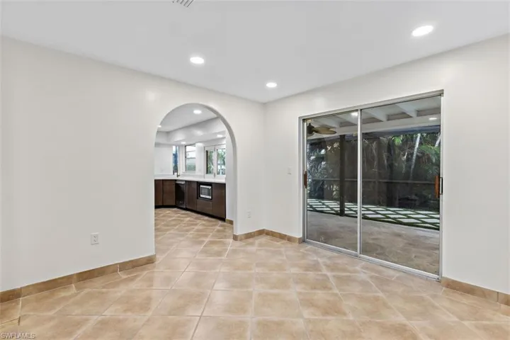 Empty room with light tile patterned flooring