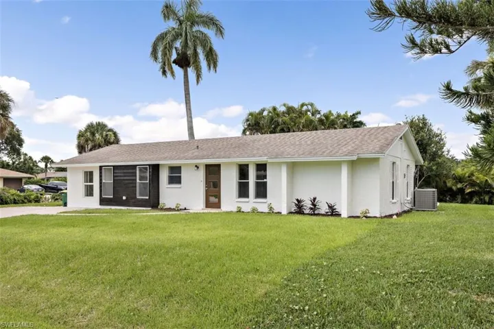 View of front facade with central AC unit and a front yard