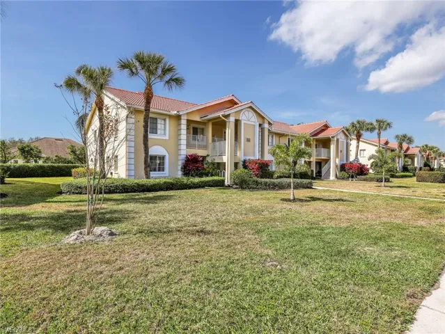 Mediterranean / spanish-style home with a front yard, stucco siding, and a balcony
