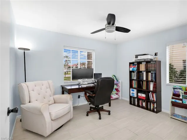 Home office with baseboards and a ceiling fan