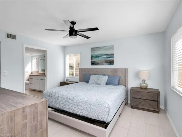 Bedroom featuring connected bathroom and ceiling fan