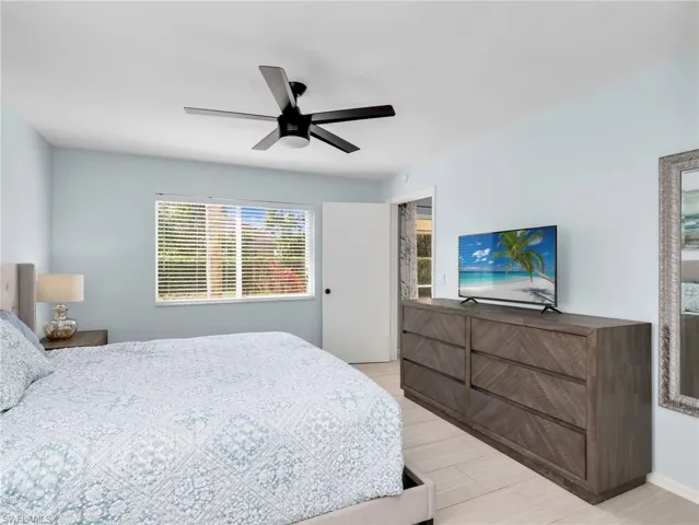 Bedroom with a ceiling fan and access to outside