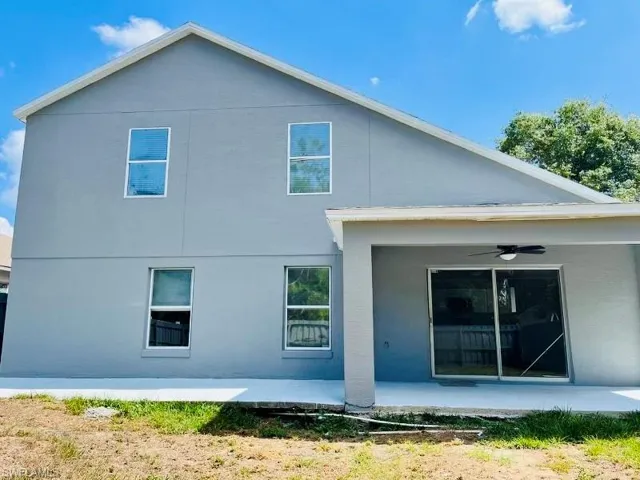 Back of property featuring stucco siding, a patio area, and ceiling fan