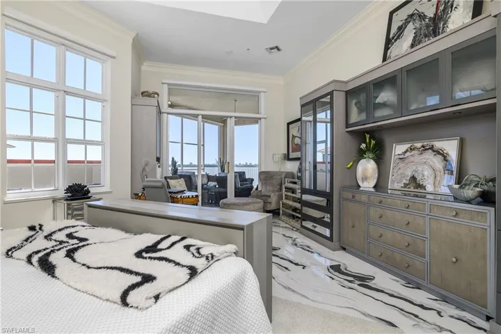 Bedroom with visible vents, marble finish floor, crown molding, and access to outside