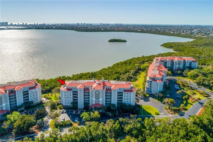 Aerial view featuring a city view and a water view