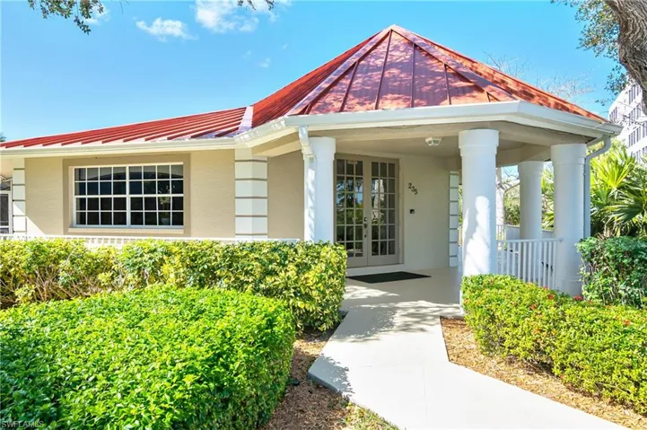 View of exterior entry with stucco siding and french doors