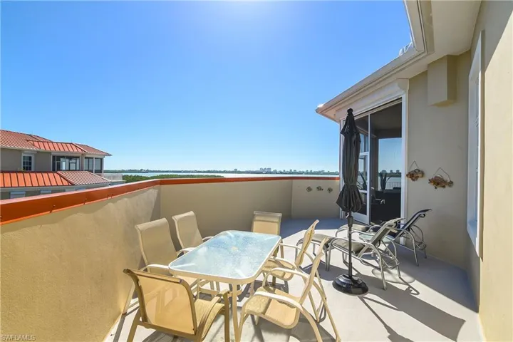View of patio featuring a balcony