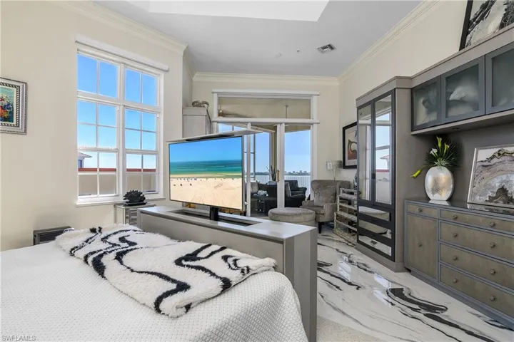 Bedroom with visible vents, marble finish floor, a skylight, and crown molding