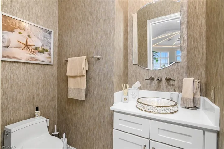 Half bathroom with vanity and toilet