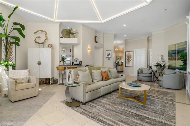Tiled living area featuring recessed lighting and ornamental molding