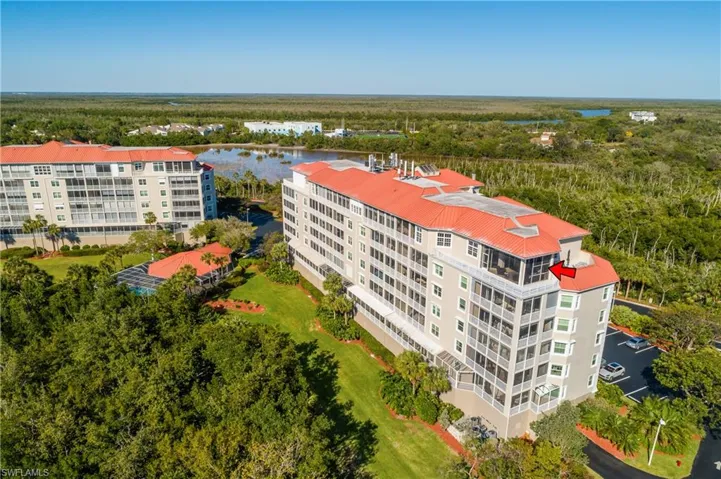 Birds eye view of property with a water view