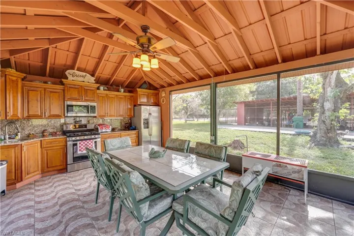 155 Evans Rd, LaBelle, FL 33935 Outdoor kitchen/party room with ceiling fan, sink, and vaulted ceiling