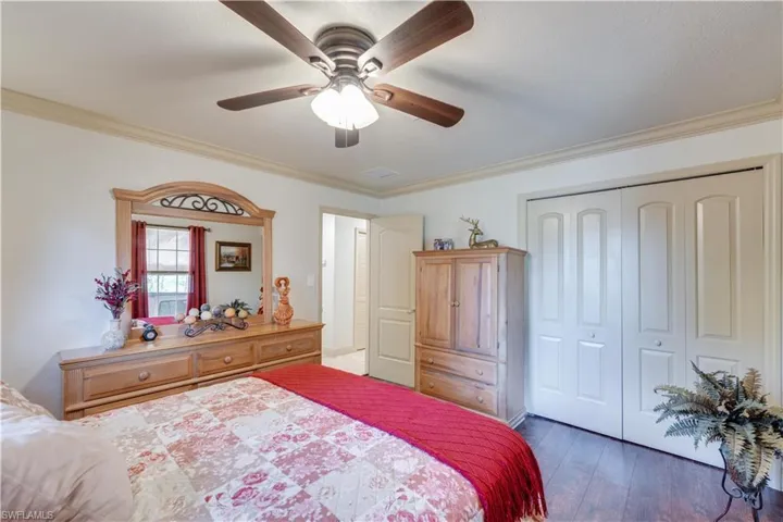 155 Evans Rd, LaBelle, FL 33935 Bedroom with a closet, ceiling fan, ornamental molding, and dark hardwood / wood-style floors