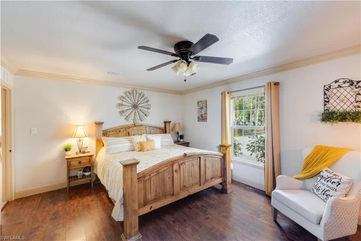 155 Evans Rd, LaBelle, FL 33935 Large bedroom with ceiling fan, crown molding, and dark wood-type flooring