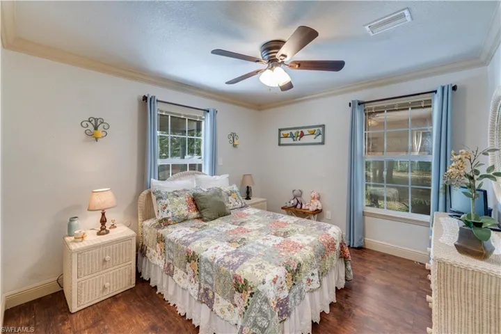 155 Evans Rd, LaBelle, FL 33935 Bedroom with ceiling fan, dark hardwood / wood-style flooring, ornamental molding, and a textured ceiling
