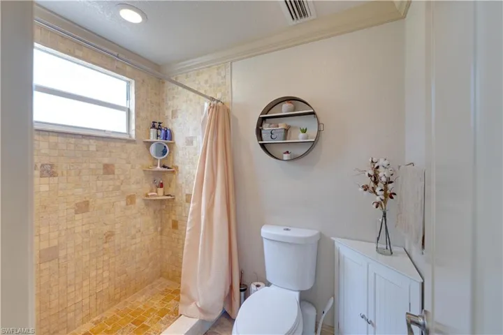 155 Evans Rd, LaBelle, FL 33935 Bathroom with a shower with curtain, toilet, and ornamental molding