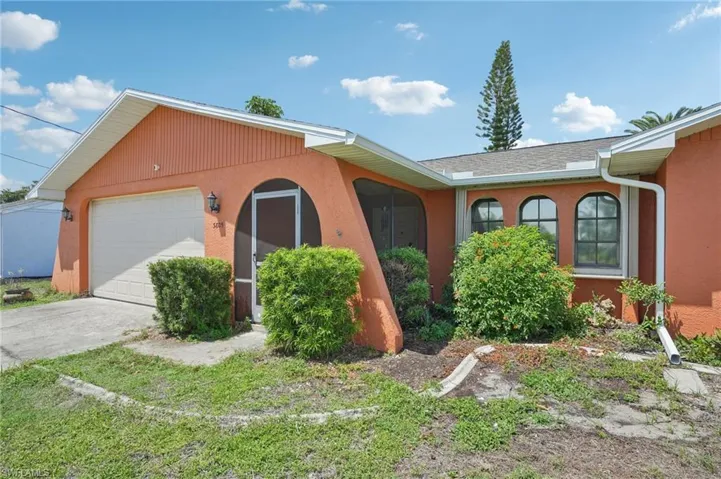 Single story home with a garage, concrete driveway, and stucco siding