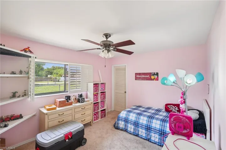Bedroom featuring light carpet and a ceiling fan
