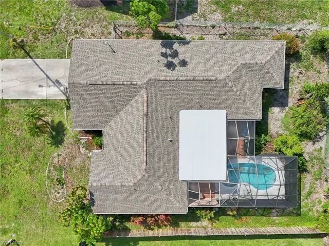 View of subject property featuring a pool