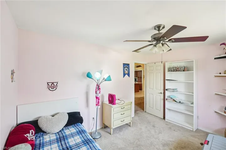 Bedroom with light carpet and ceiling fan
