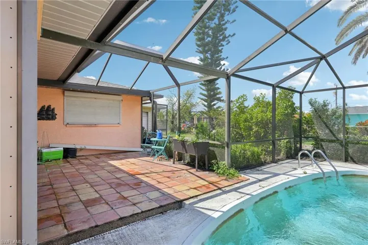 Outdoor pool with a patio and a lanai