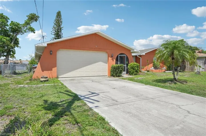 Ranch-style house featuring an attached garage and concrete driveway