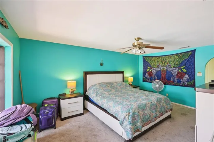 Carpeted bedroom with ceiling fan