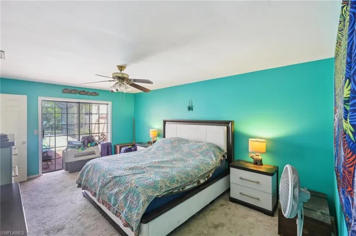 Bedroom with carpet floors, ceiling fan, and access to exterior