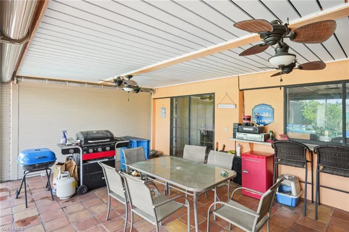 View of patio / terrace featuring outdoor dining area, a ceiling fan, and area for grilling