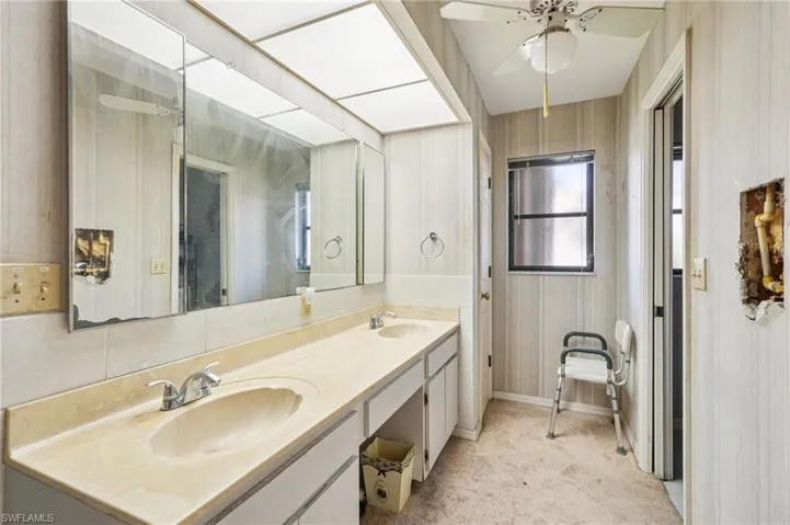 Full bathroom featuring double vanity and a ceiling fan