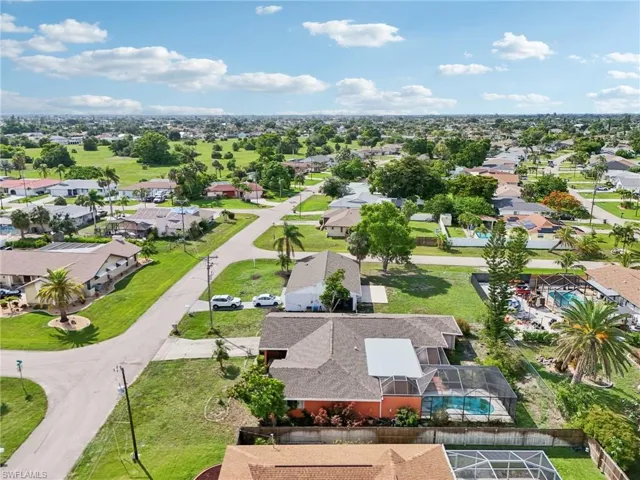 Aerial view of residential area featuring a pool