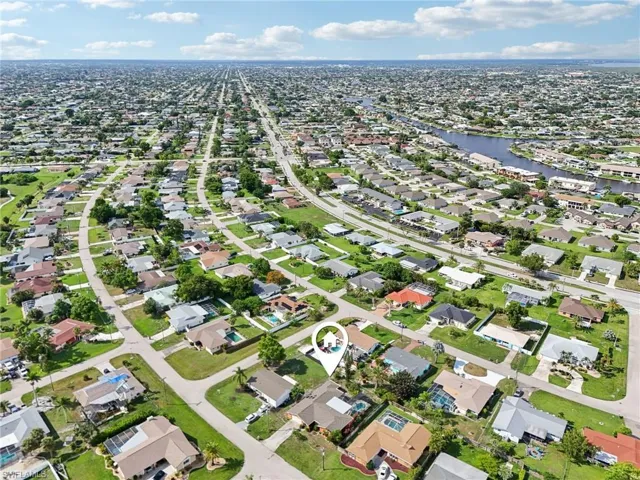 Aerial view of property's location with nearby suburban area and a nearby body of water