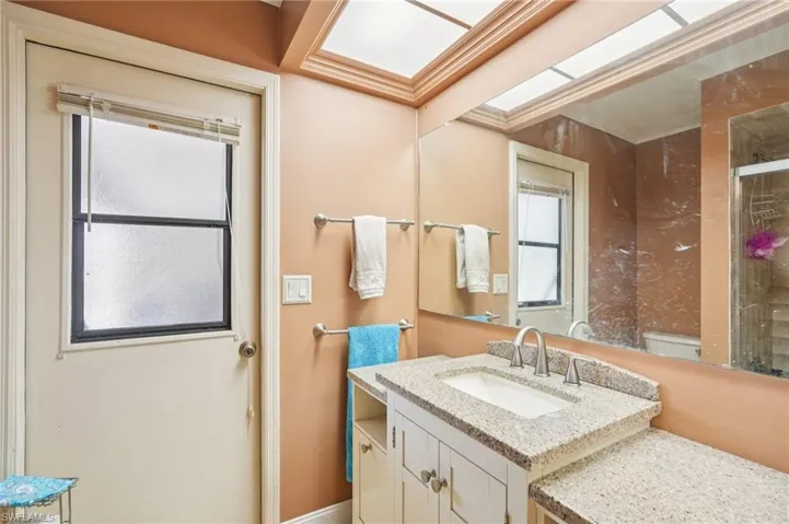 Bathroom featuring vanity and a tile shower