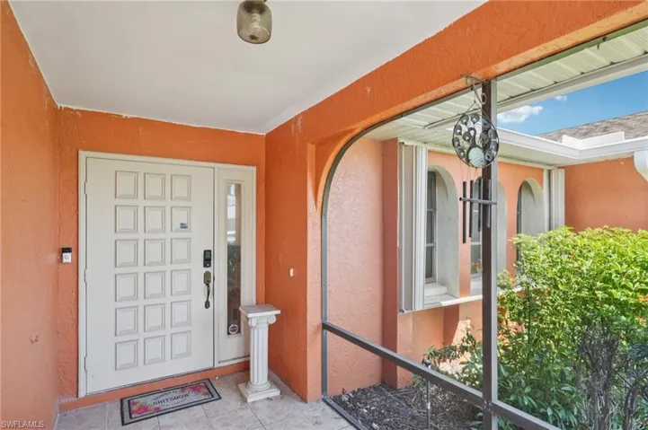 Entrance to property featuring stucco siding