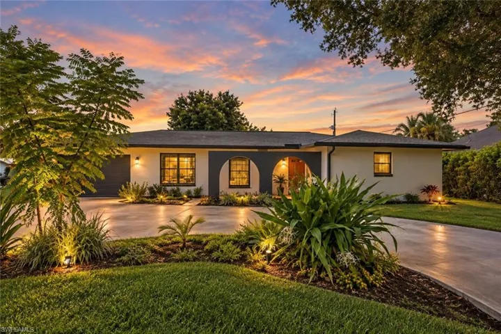 Single-story residence with a smooth stucco exterior and dark-framed windows - Virtually Improved