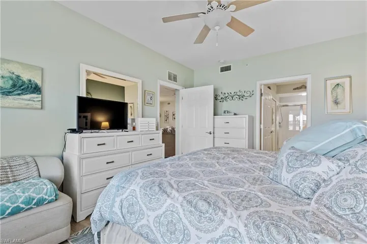 Bedroom with ceiling fan and connected bathroom