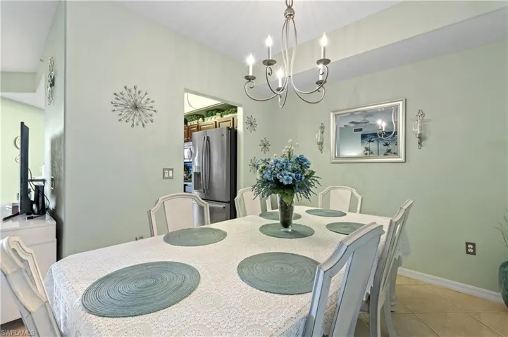 Dining room featuring hanging lights and light tile patterned floors