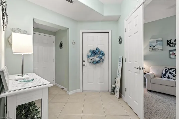Entrance foyer with light tile patterned floors