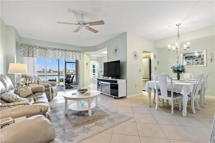 Living room with tile patterned floors, and ceiling fan