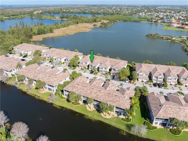 View of property location featuring a nearby body of water and nearby suburban area