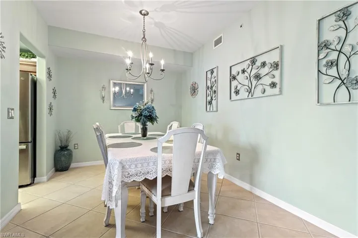 Dining space featuring a chandelier and light tile patterned flooring
