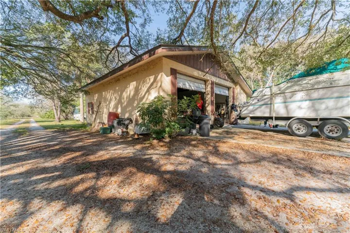 View of side of property featuring an outdoor structure