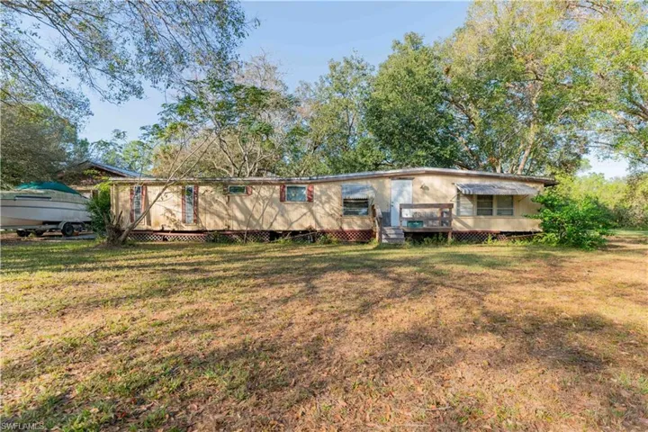 Rear view of house with a yard