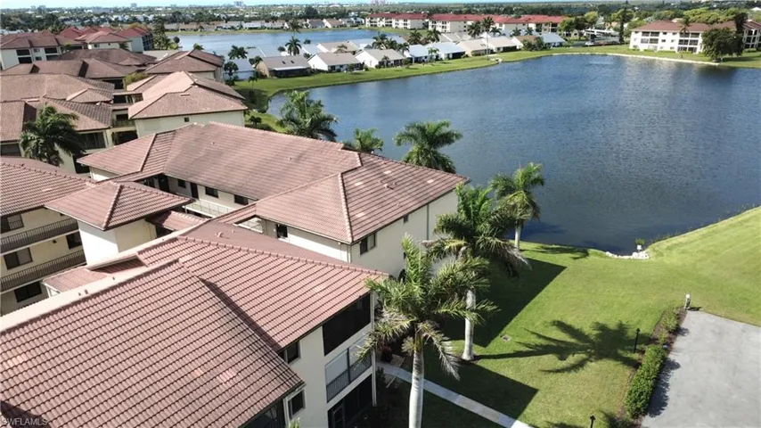Aerial perspective of suburban area with a nearby body of water