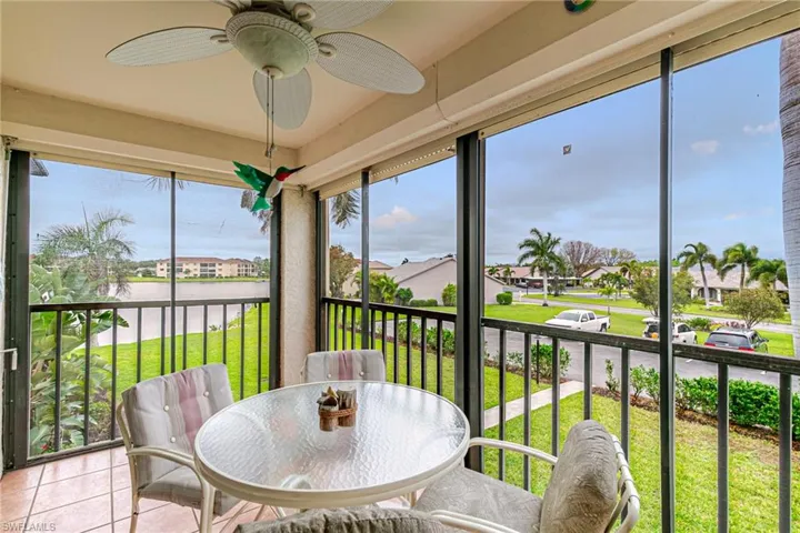 Sunroom with tile patterned floors, healthy amount of natural light, and a residential view