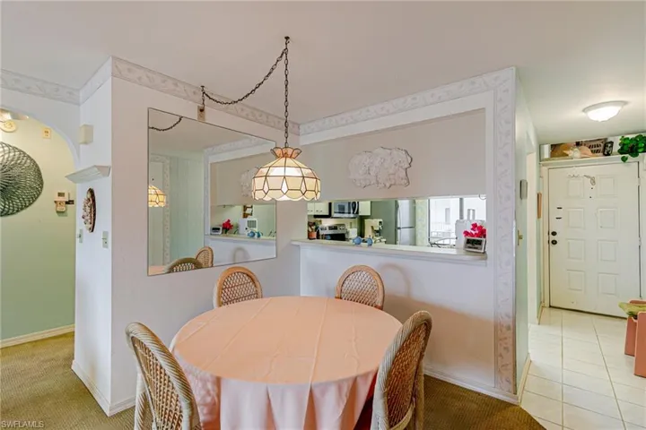 Dining room featuring light colored carpet and baseboards