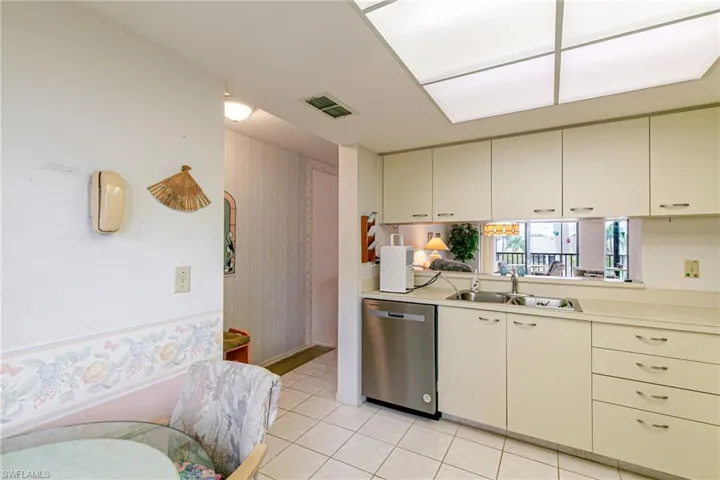 Kitchen featuring light countertops, dishwasher, and light tile patterned floors